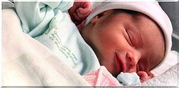 Smiling baby asleep in her crib