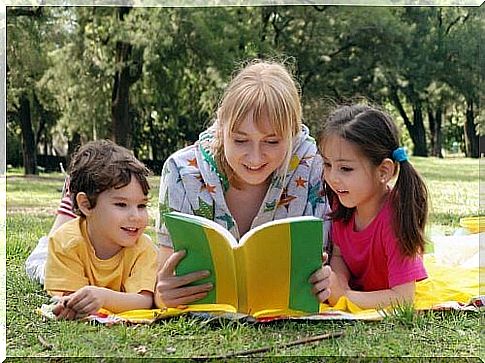 mother reading to her children, helping her child to study