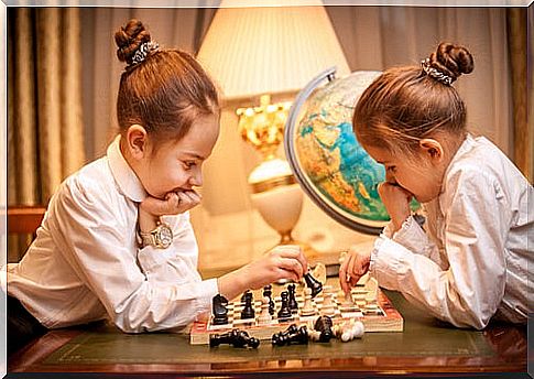 twin girls playing chess